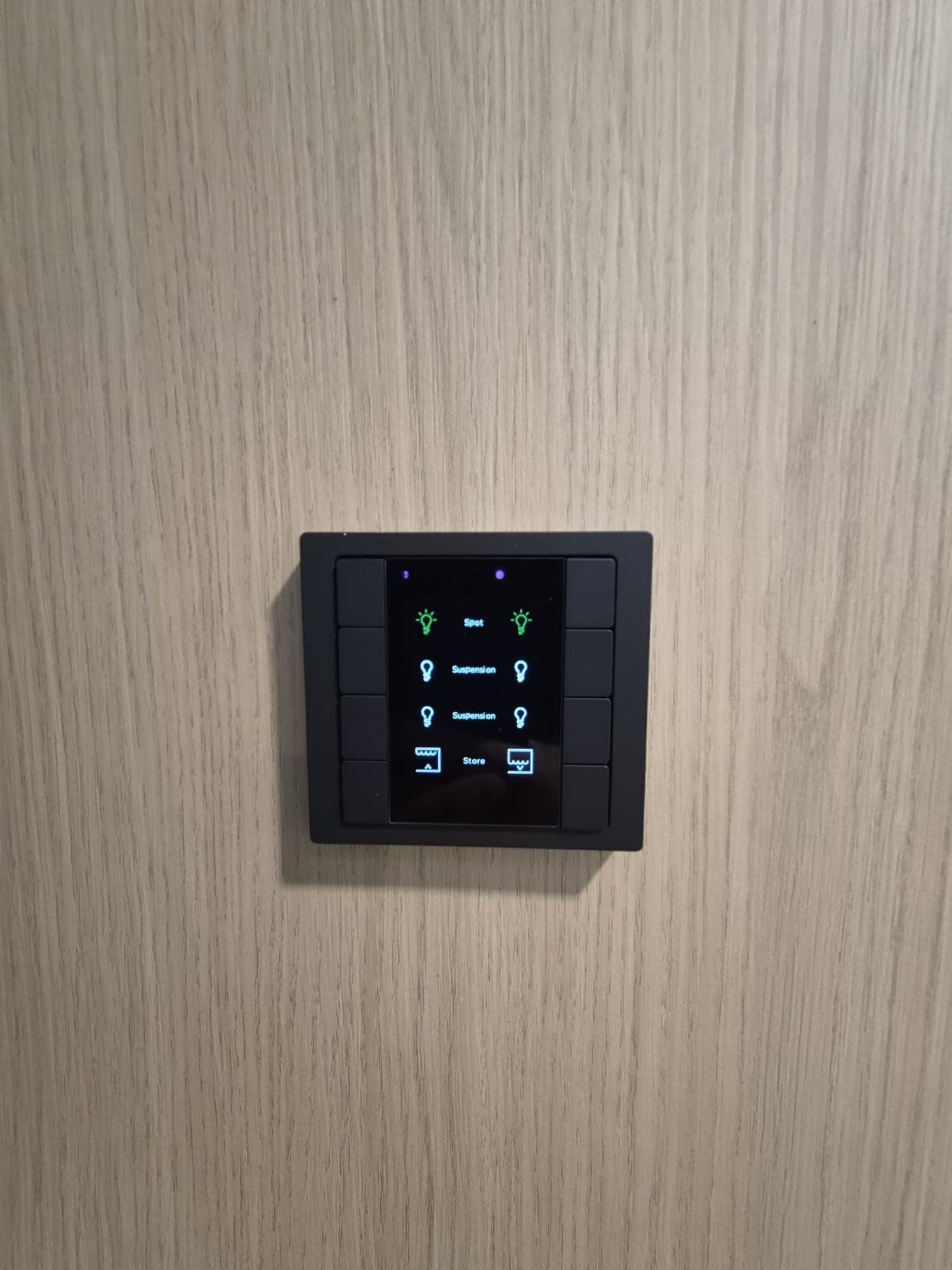 KNX push-button panel with display on a wooden panel